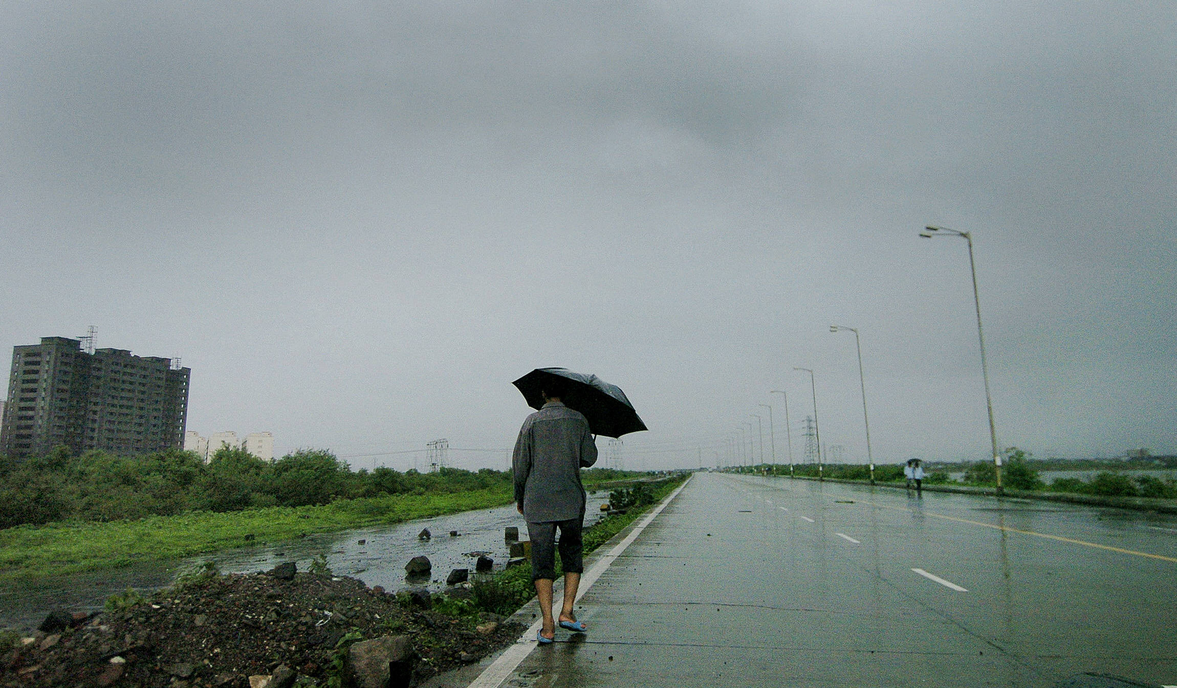A Mumbai resident makes his way home along the deserted Wadala highway
