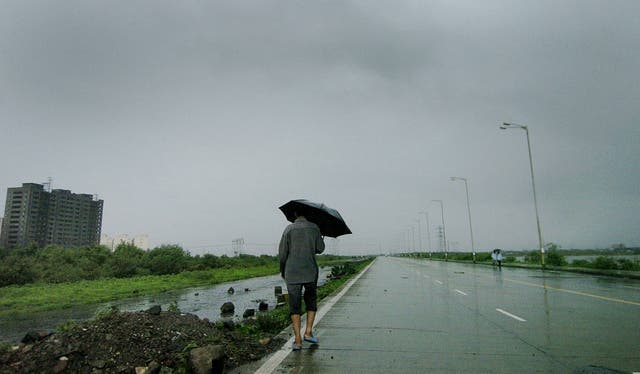 <p>A Mumbai resident makes his way home along the deserted Wadala highway</p>
