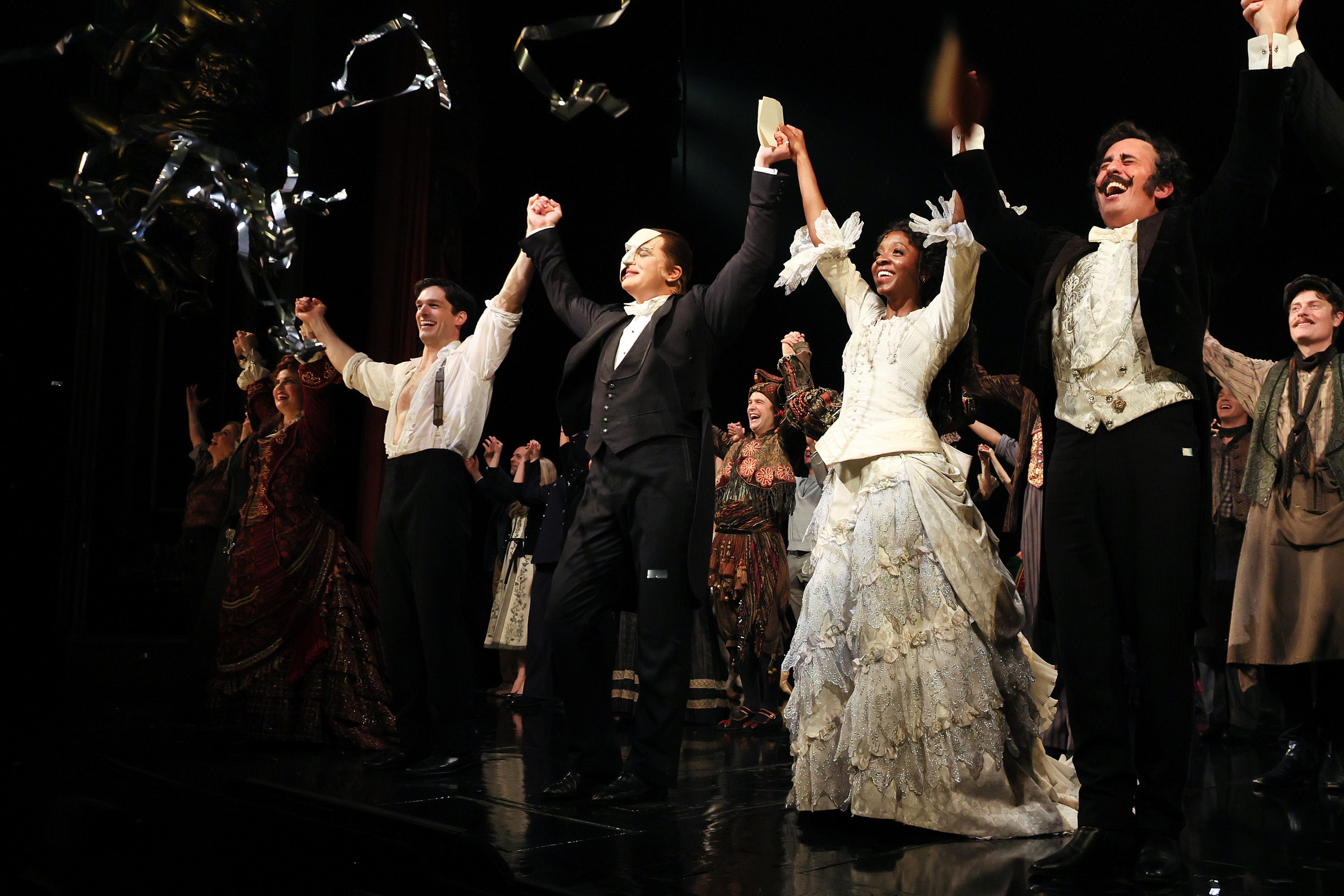 John Riddle as Raoul, Ben Crawford as The Phantom, and Emilie Kouatchou as Christine, and cast take their curtain call on the 35th anniversary of ‘The Phantom of the Opera’ on Broadway at the Majestic Theatre