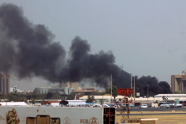 <p>Heavy smoke bellows above buildings in the vicinity of the Khartoum airport on Saturday, amid clashes in the Sudanese capital</p>