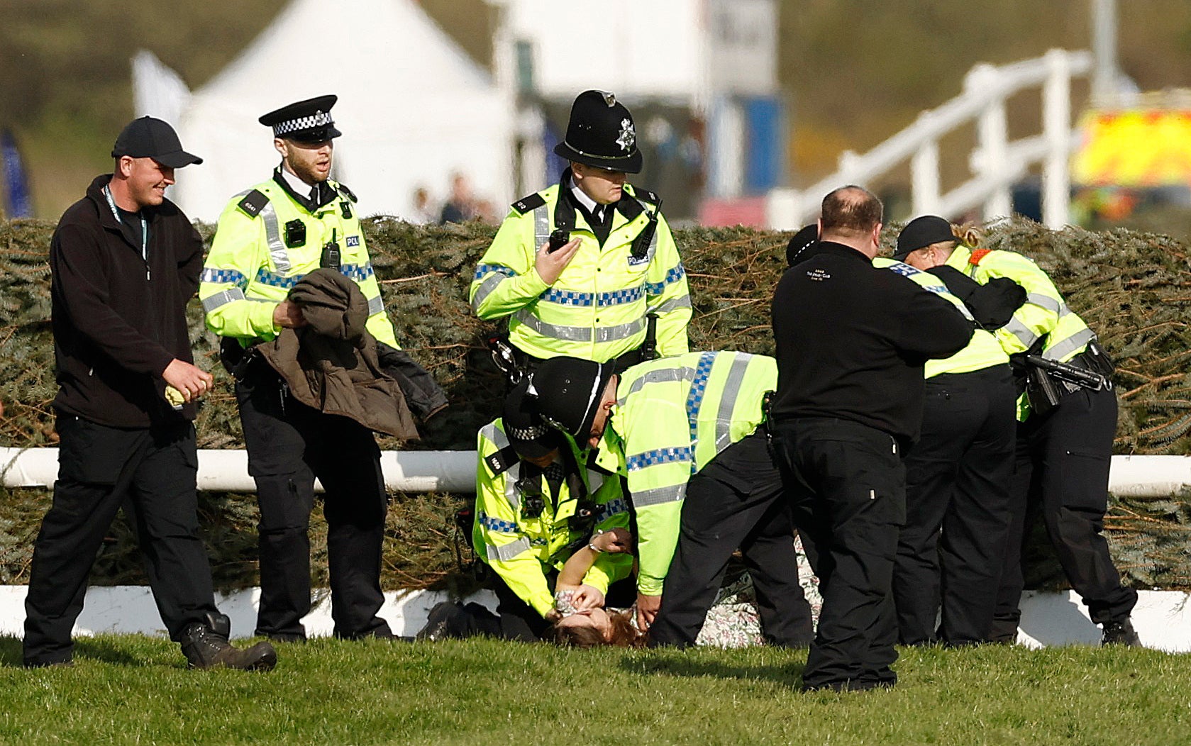 Police contain protestors on the Aintree racecourse