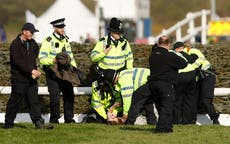 Grand National delayed after animal rights protestors breach Aintree course