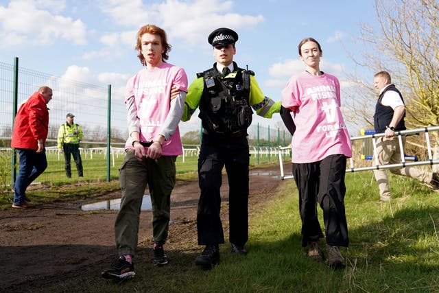Activists being removed by police at Aintree Racecourse (Tim Goode/PA)