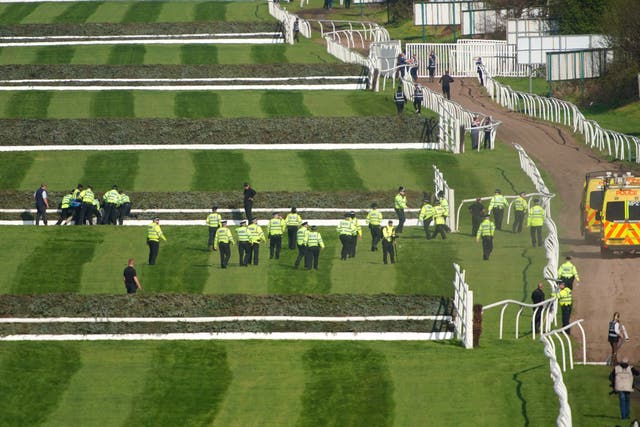 Police officers respond to Animal Rising activists attempting to invade the race course ahead of the Randox Grand National (Peter Byrne/PA).