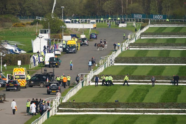 Police officers respond to Animal Rising activists attempting to invade the race course ahead of the Randox Grand National (Peter Byrne/PA)