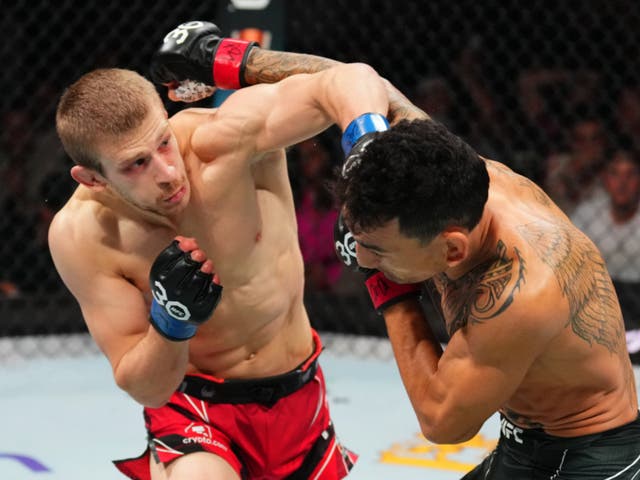 <p>Max Holloway (right) was a decision winner against Arnold Allen in a competitive bout</p>