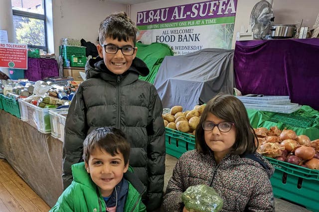 (from left to right) Kamran, Harris and Eve Javaid at the food bank (Sarah Javaid)