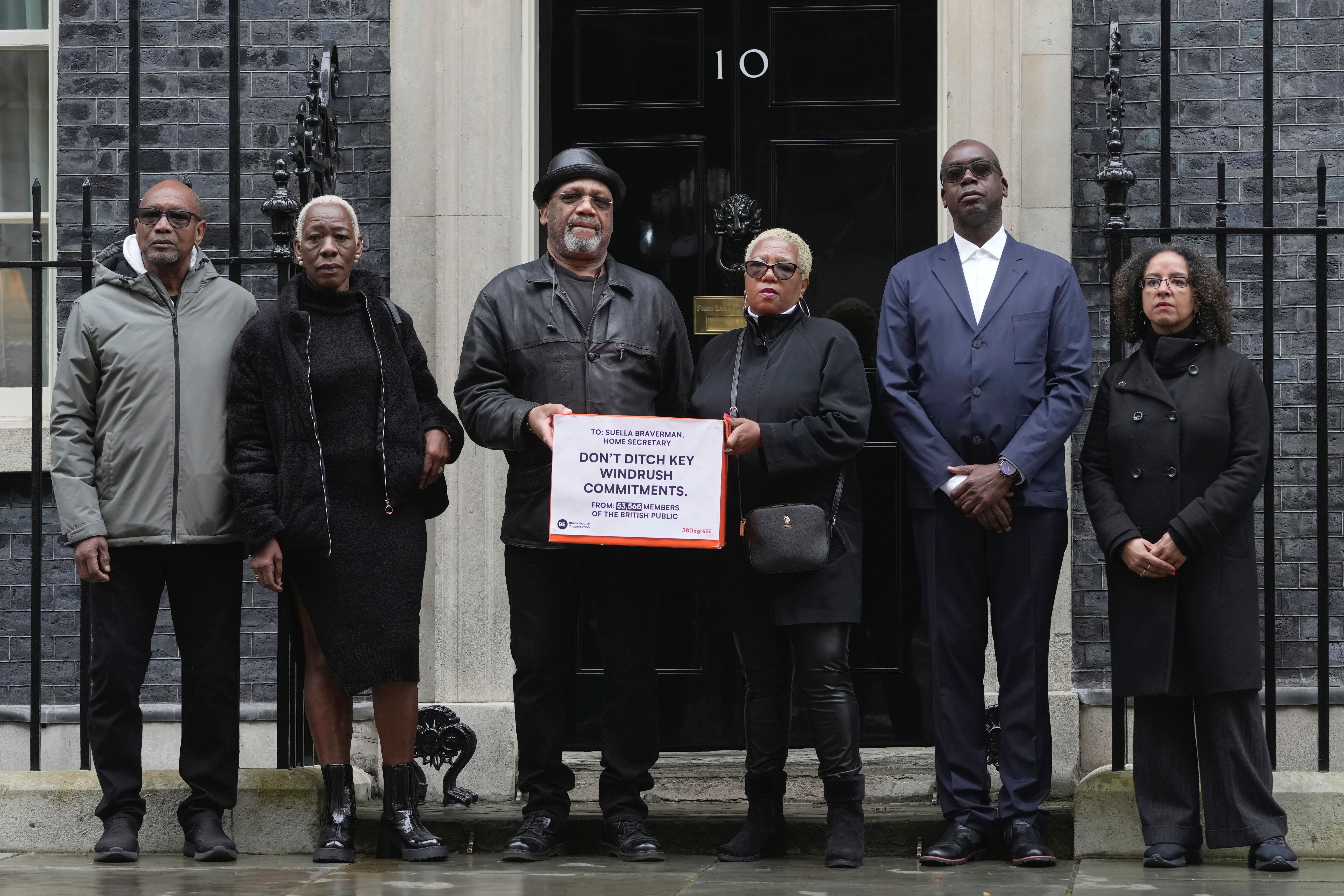 A report from a global human rights organisation has revealed victims of the Windrush scandal are still being subjected to long waits and subject to being underpaid for their compensation claims. From left, Windrush campaigners Michael Anthony Braithwaite, Janet Mckay-Williams, Auckland Elwaldo Romeo, Glenda Caesar, Patrick Vernon and Dr Wanda Wyporska pose for photograph as they hand in a letter to Downing Street, in London, Thursday April, 6, 2023. (Kin Cheung, AP)