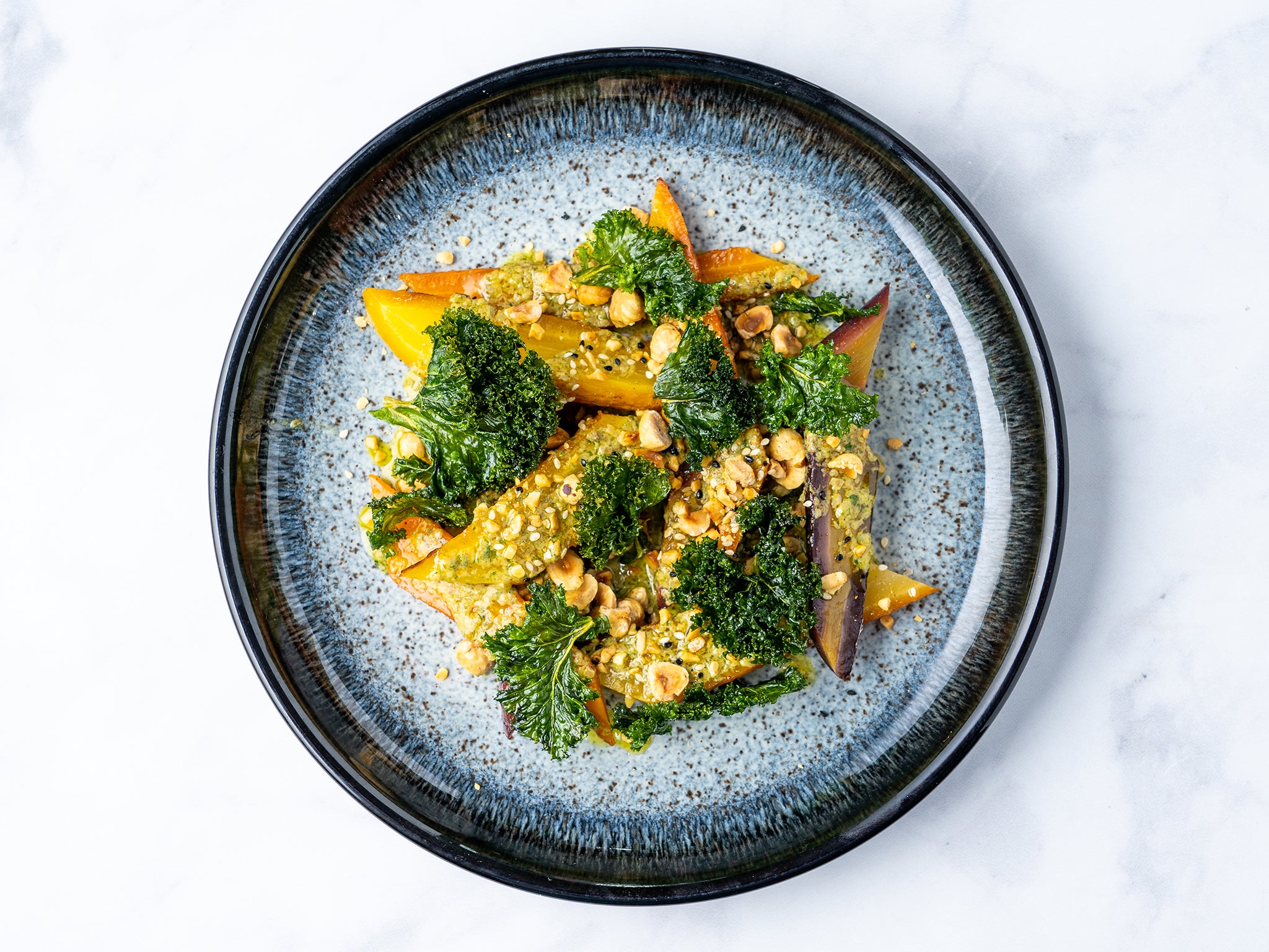 With cafe de Paris butter, dukkah and kale, these carrots are a centrepiece in their own right