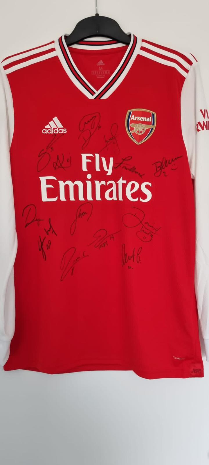 An Arsenal shirt signed by the men’s first team gifted to Mr Cain wishing him a good recovery