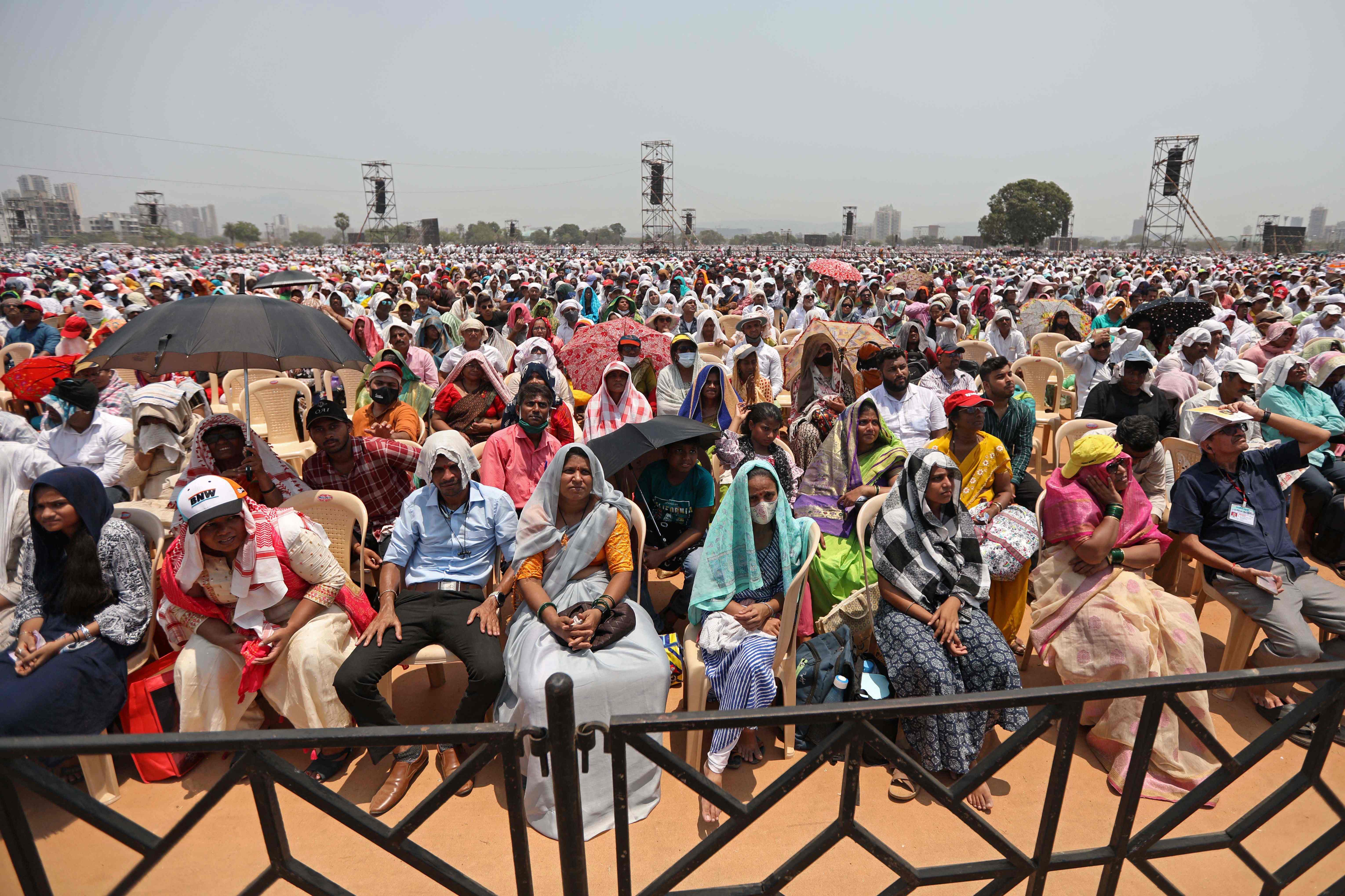 People gather to attend an award ceremony that led to the deaths of 11 people on the outskirts of Mumbai