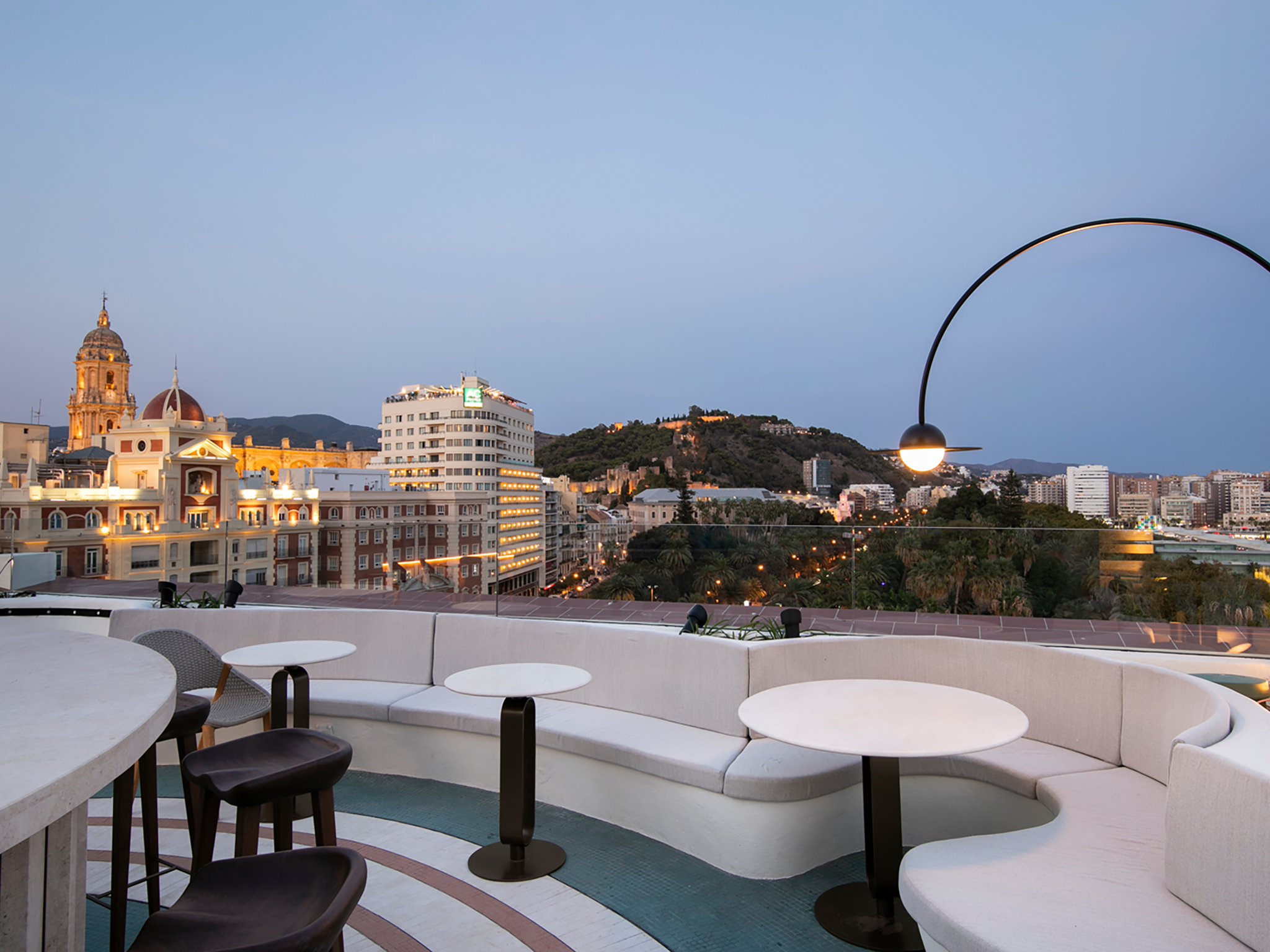 The rooftop bar reminds of a cruiseliner and has a stunning blue mosaic infinity pool