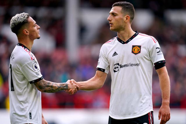Manchester United’s Diogo Dalot (right) celebrates with Antony after scoring their side’s second goal of the game during the Premier League match at the City Ground, Nottingham. Picture date: Sunday April 16, 2023.