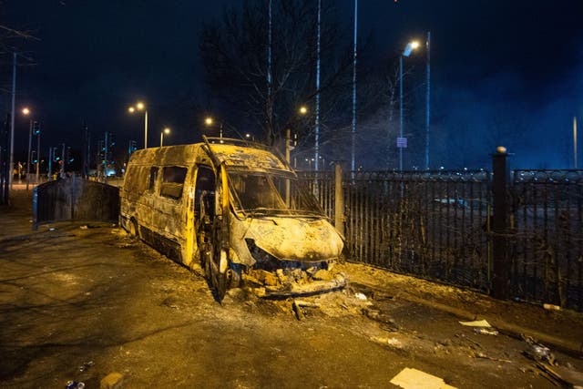 A burnt-out police van after a demonstration outside the Suites Hotel in Knowsley, Merseyside (Peter Powell/PA)