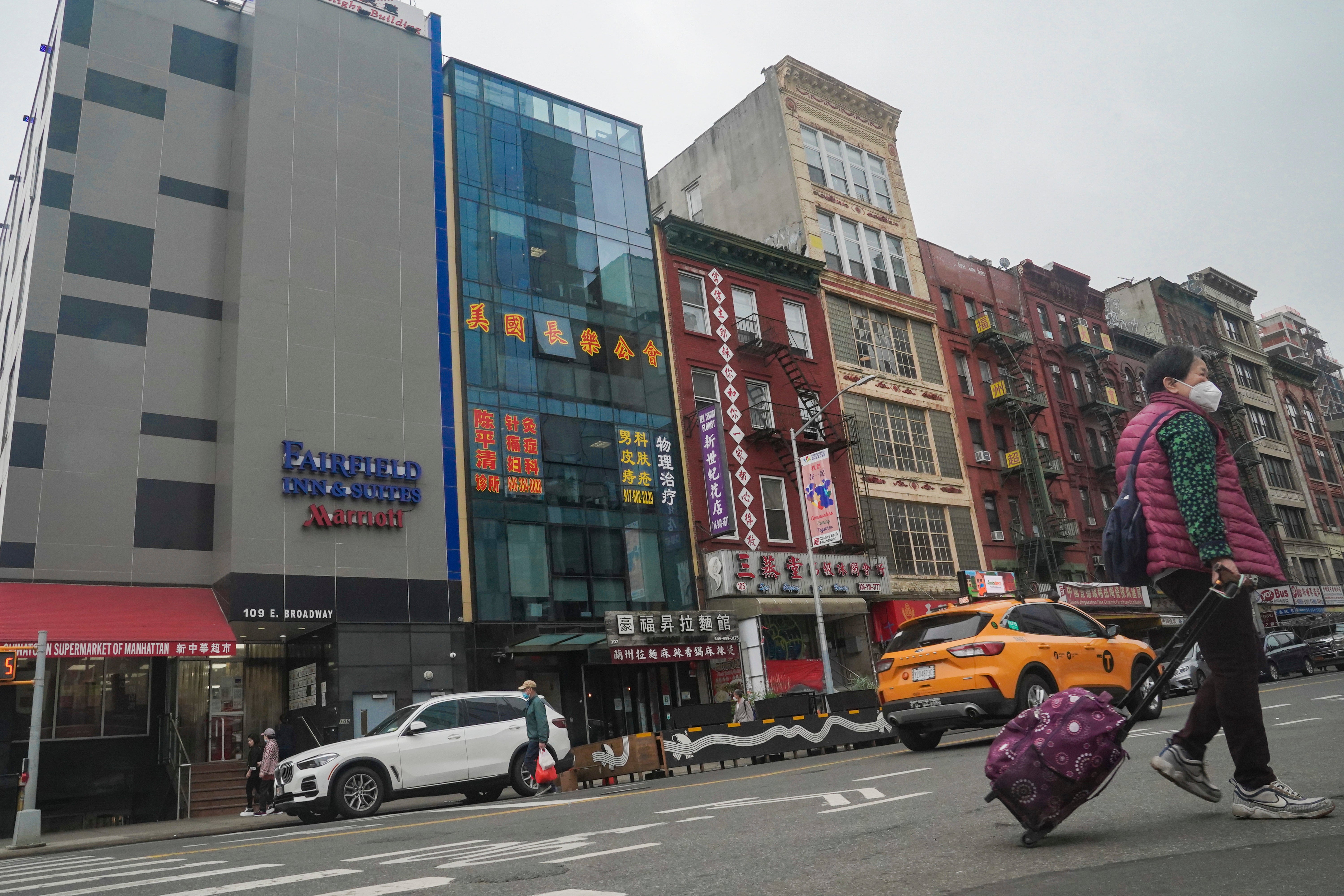 A six storey glass facade building, second from left, believed to be the site of a Chinese police outpost in New York City's Chinatown district