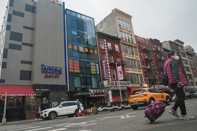 <p>A six storey glass facade building, second from left, believed to be the site of a Chinese police outpost in New York City's Chinatown district </p>