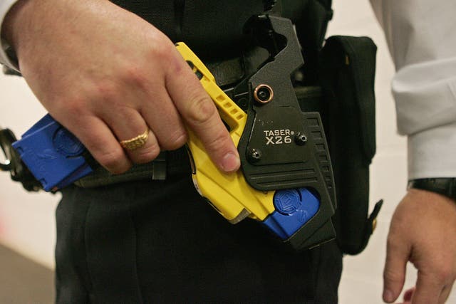 <p>A British police officer holsters a taser gun at the Metropolitan Police Specialist Training Centre in Kent</p>