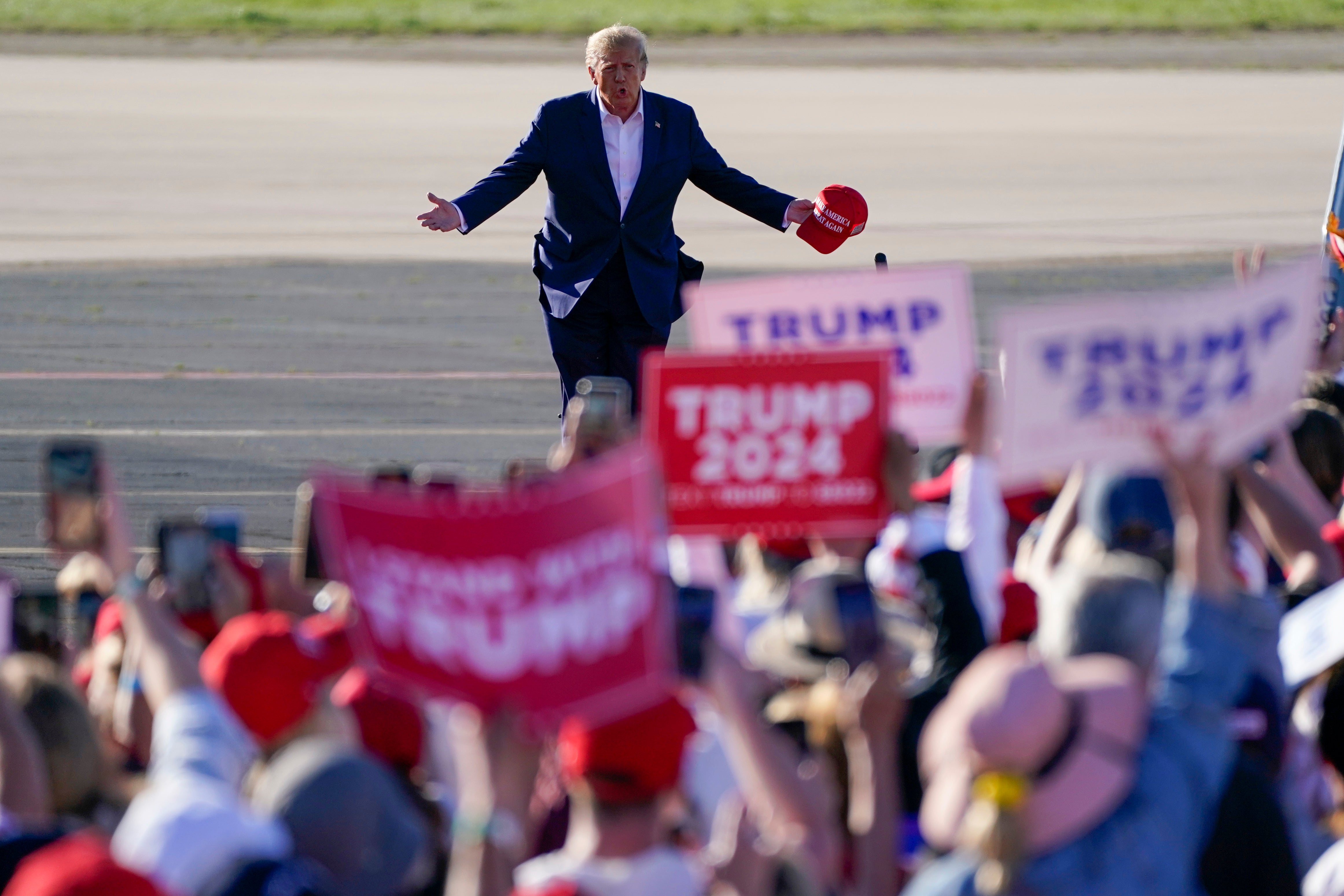 Former President Donald Trump walks across the tarmac as he arrives in Waco to speak at a campaign rally at Waco Regional Airport on March 25, 2023