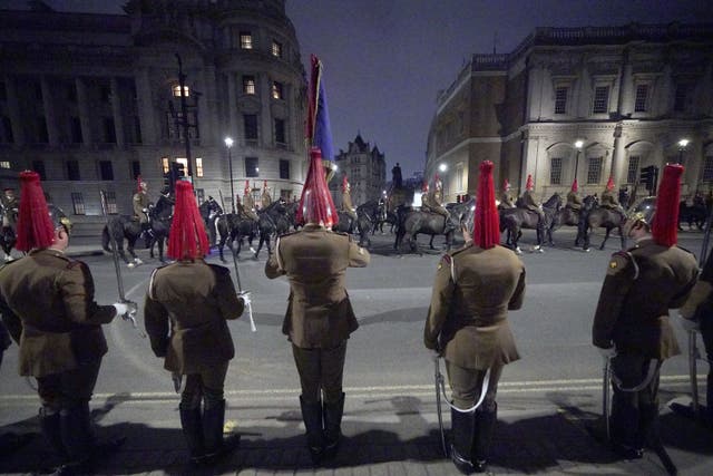 Members of the military on Whitehall, central London, during a night -time rehearsal for the King’s coronation (Yui Mok/PA)