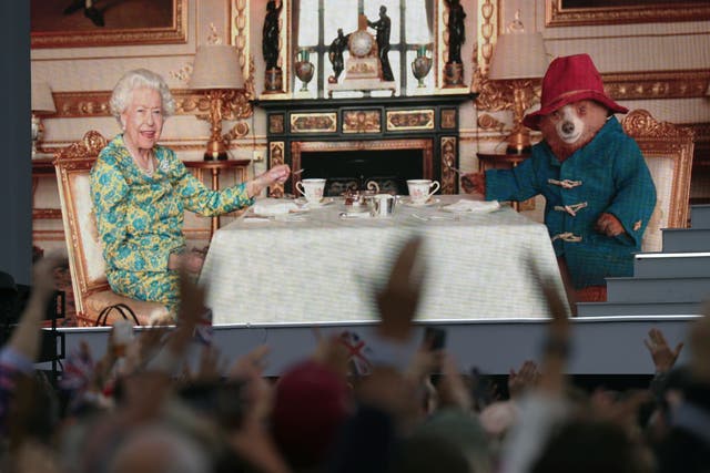 The crowd watching a film of the Queen having tea with Paddington Bear during the Platinum Jubilee celebrations last year (Victoria Jones/PA)