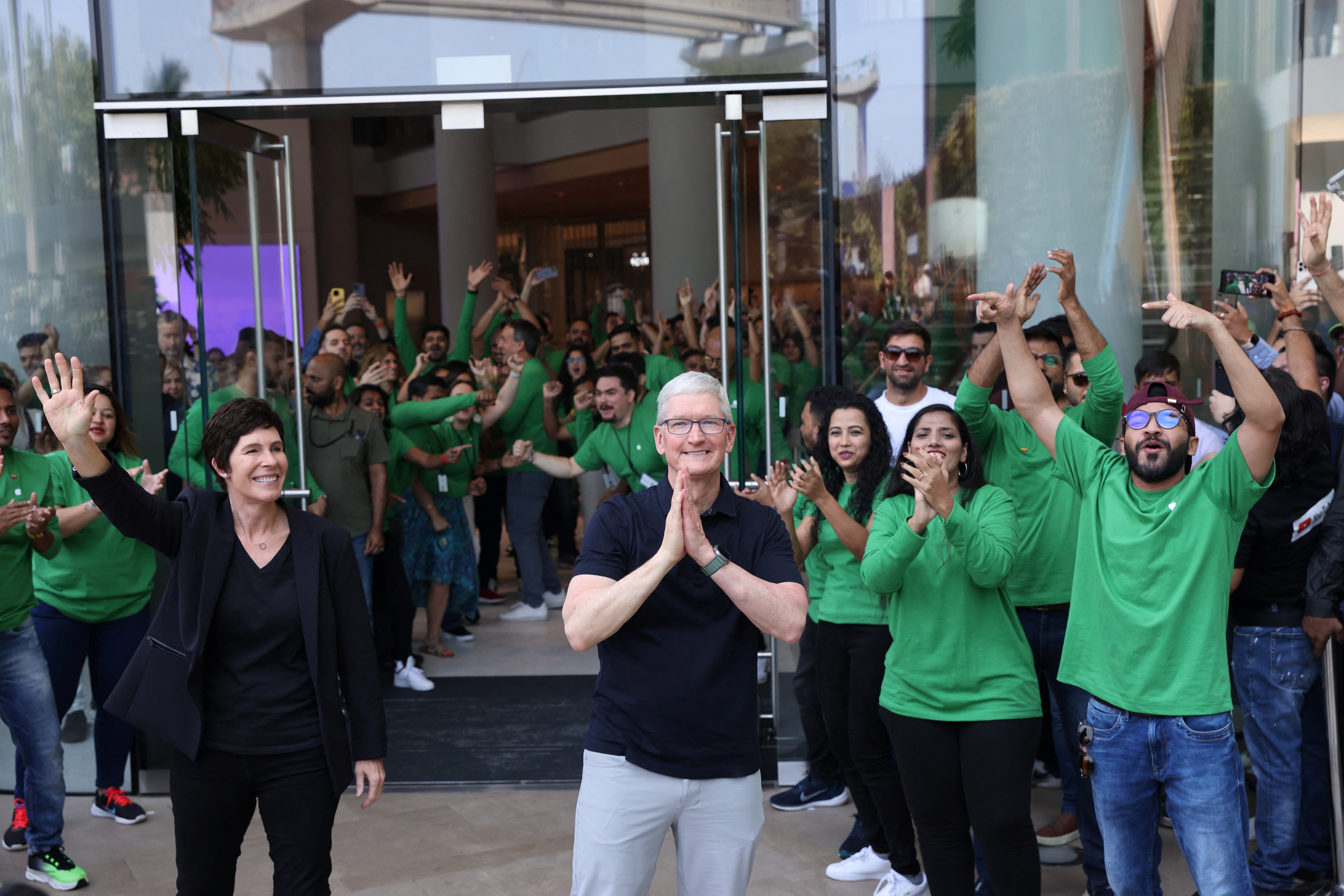 Apple CEO Tim Cook and Deirdre O’Brien, Apple’s senior vice president of Retail and People greet people at the inauguration of India’s first Apple retail store