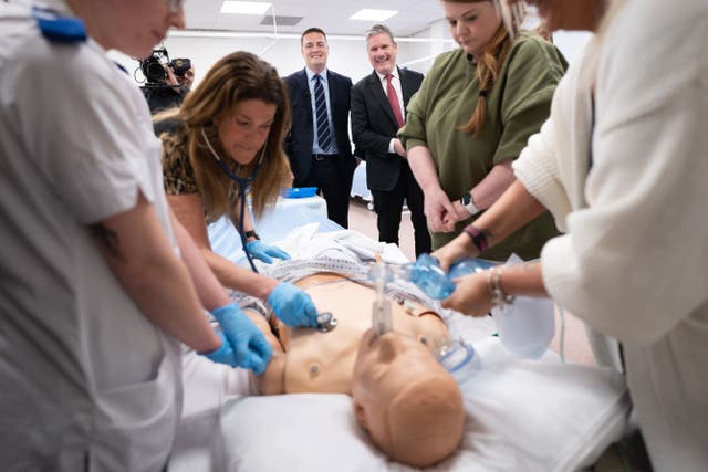 Sir Keir Starmer and Wes Streeting watch a demonstration of CPR (Stefan Rousseau/PA)