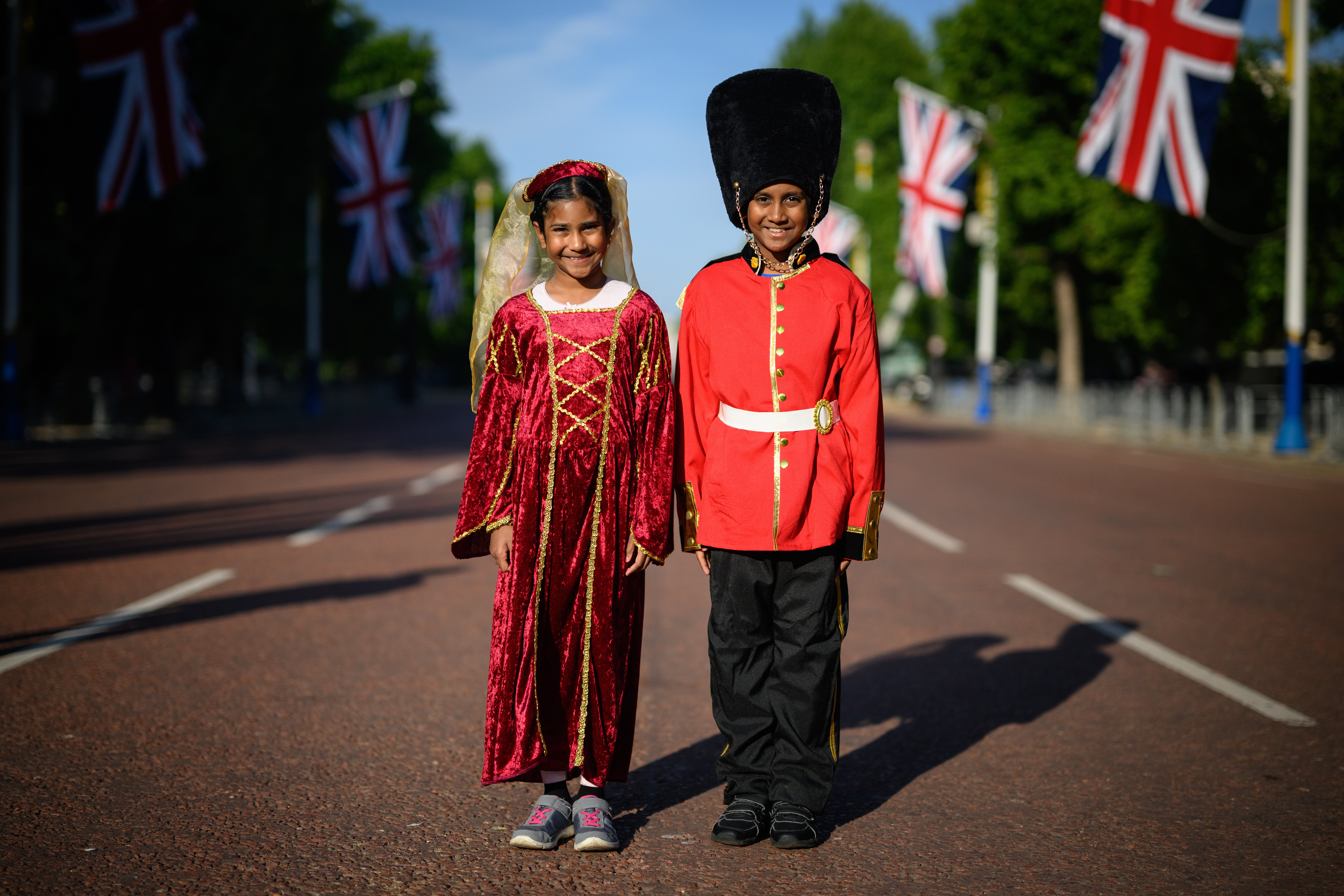 Royal fans Caellia (L) and Yoshilen wear costumes as they arrive on the Mall to celebrate the first day of celebrations to mark the Platinum Jubilee of Queen Elizabeth II, on June 02