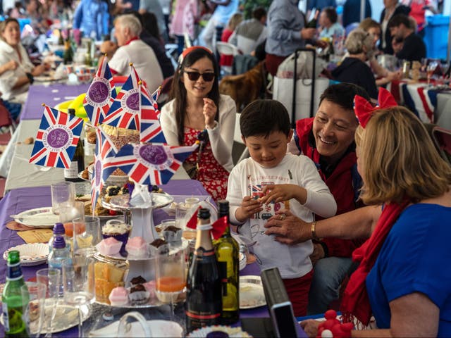<p>People enjoy a street party for Queen Elizabeth II’s platinum jubilee on June 4, 2022 in Eton</p>