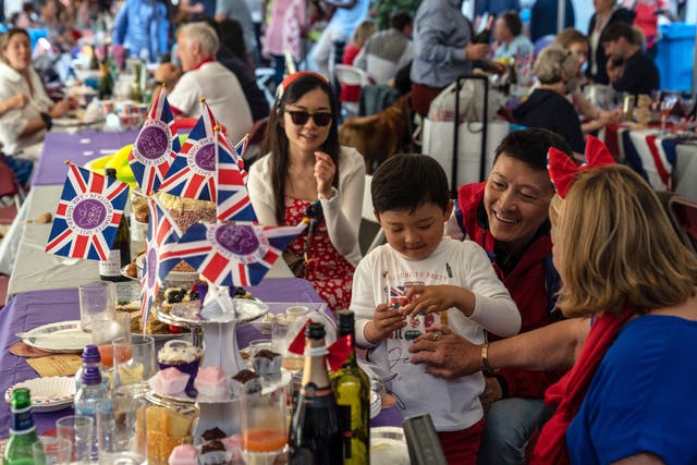 <p>People enjoy a street party for Queen Elizabeth II’s platinum jubilee on June 4, 2022 in Eton</p>