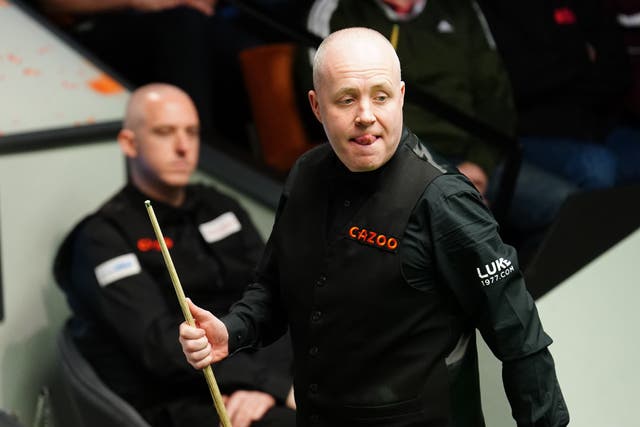 John Higgins cruised into the second round (Mike Egerton/PA)