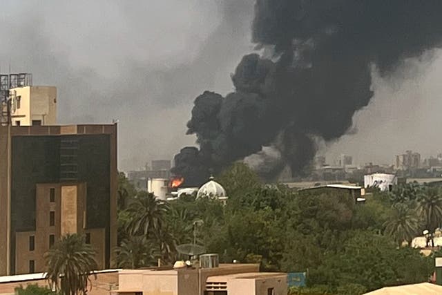 <p>Smoke billows above residential buildings in Khartoum</p>