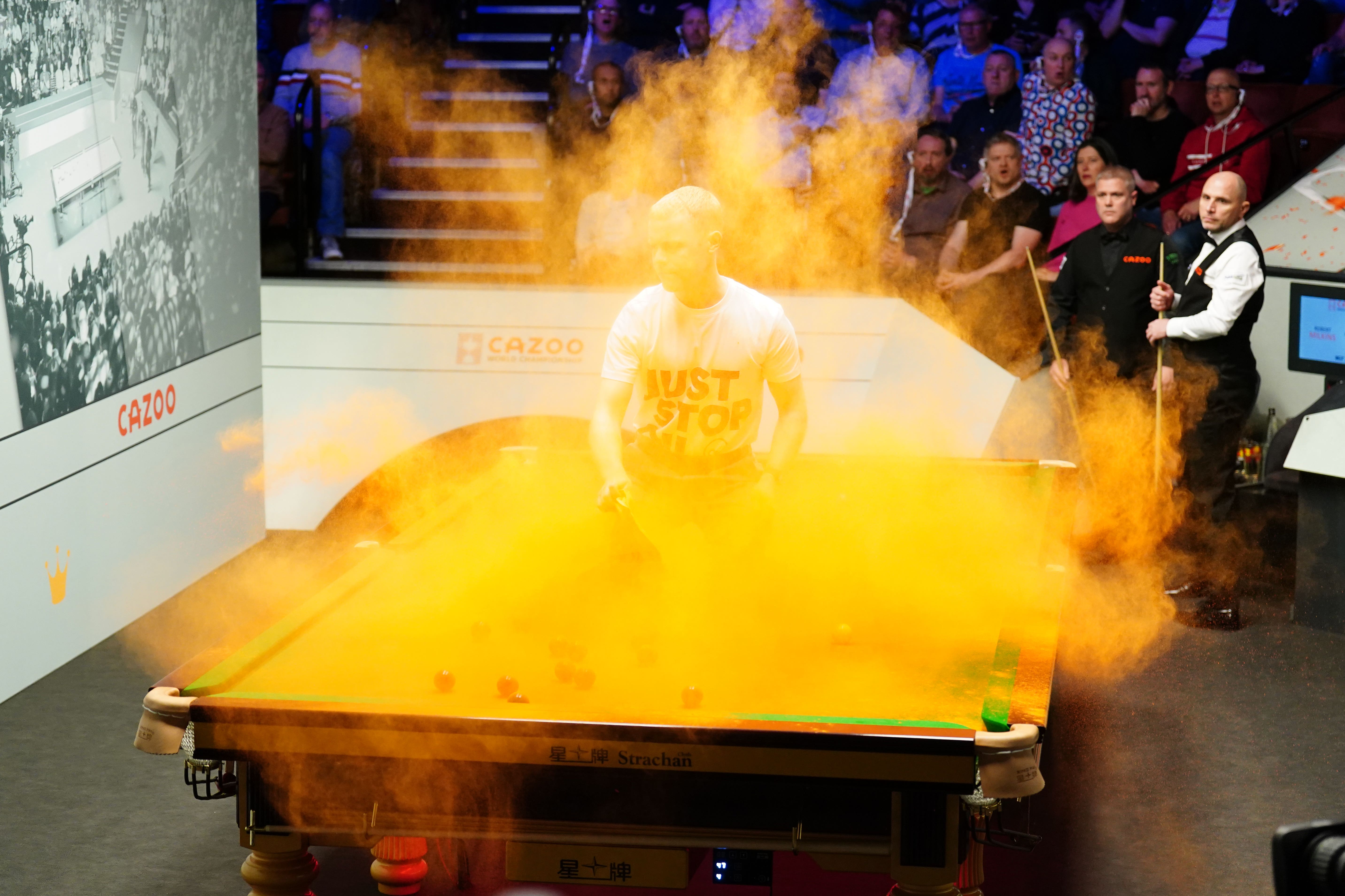 A ‘Just Stop Oil’ protester jumped on the table on Monday (Mike Egerton/PA)