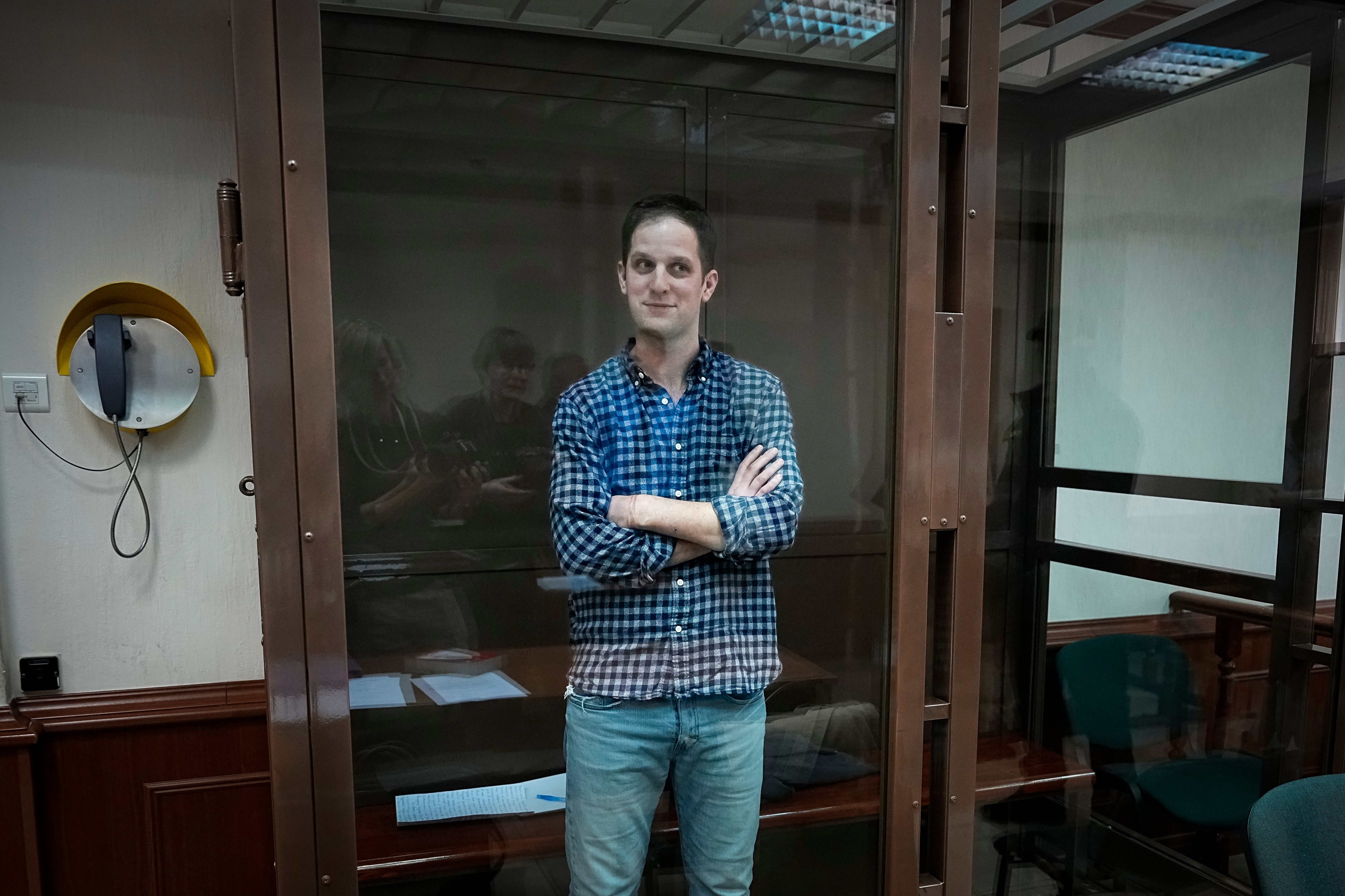 Wall Street Journal reporter Evan Gershkovich stands in a glass cage in a courtroom at the Moscow City Court, in Moscow, Russia, on Tuesday, April 18, 2023