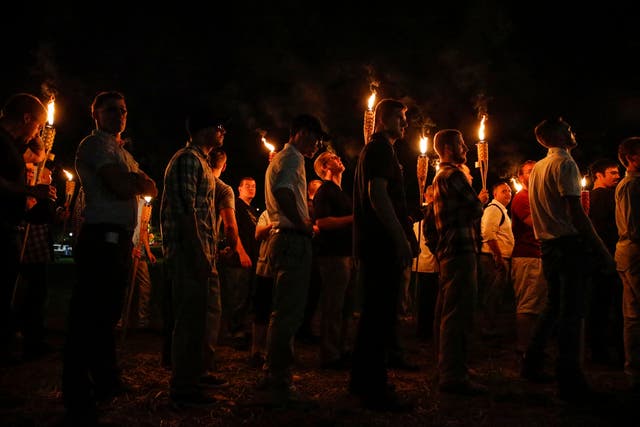 <p>Multiple white nationalist groups march with torches through the University of Virginia campus on Aug. 11, 2017, in Charlottesville, Virginia. Donald Trump said that the Charlottesville rally was ‘peanuts’ compared to pro-Palestine campus demonstrations </p>