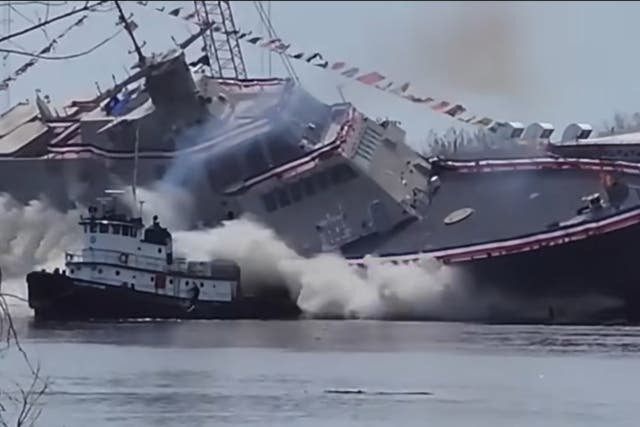 <p>The US Navy warship tilted towards the tugboat in a dramatic launch on Saturday. Screengrab</p>