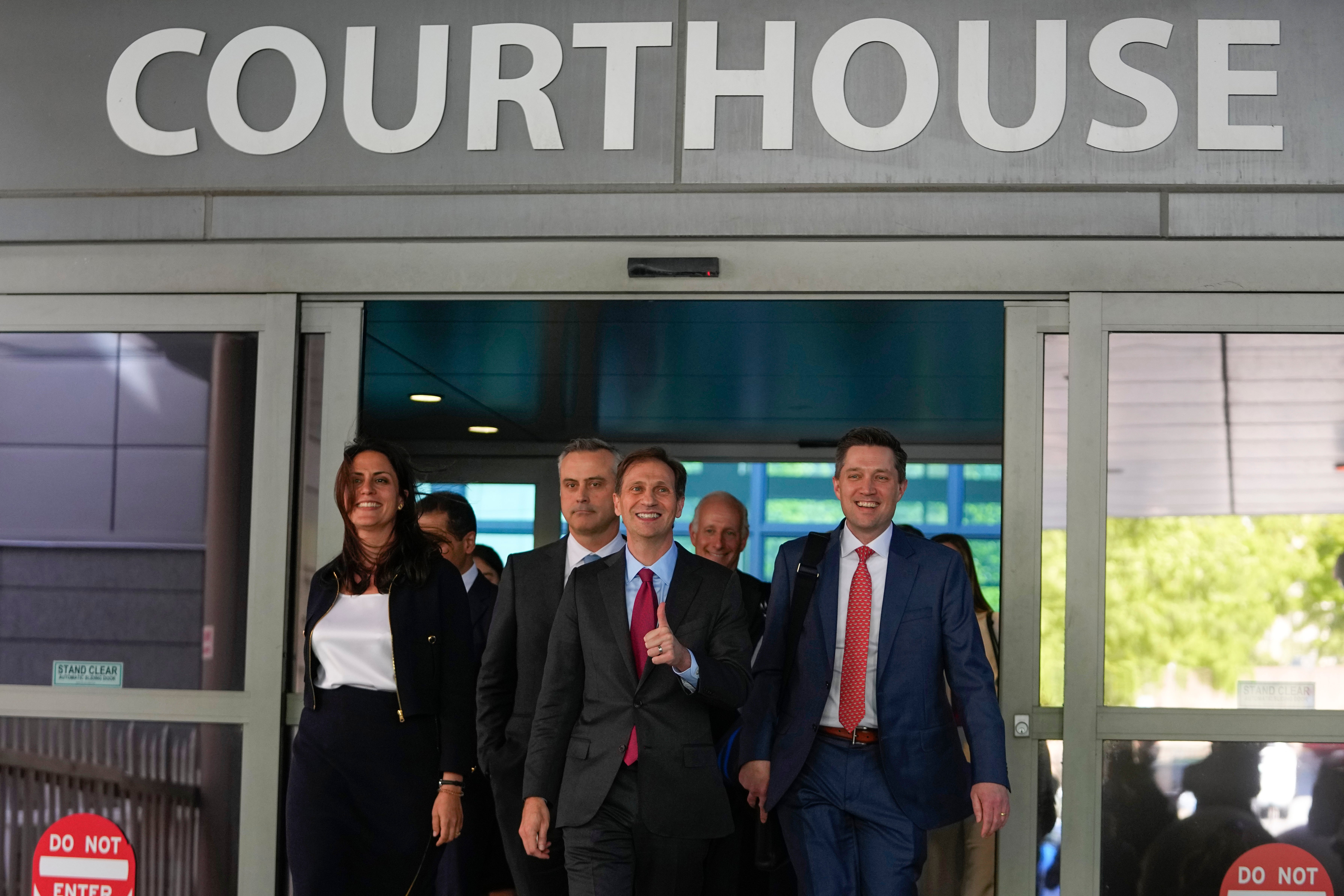 Dominion Voting Systems attorneys Davida Brook, left, Justin Nelson, centre, and Stephen Shackelford exit the Delaware Superior Court after Monday’s settlement.