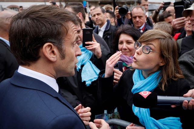 <p>French President Emmanuel Macron, left, talks to France National Union of Autonomous Trade Unions general secretary for the Grand Est region, Chloe Bourguignon, re her opposition to the pension reform, in Selestat</p>