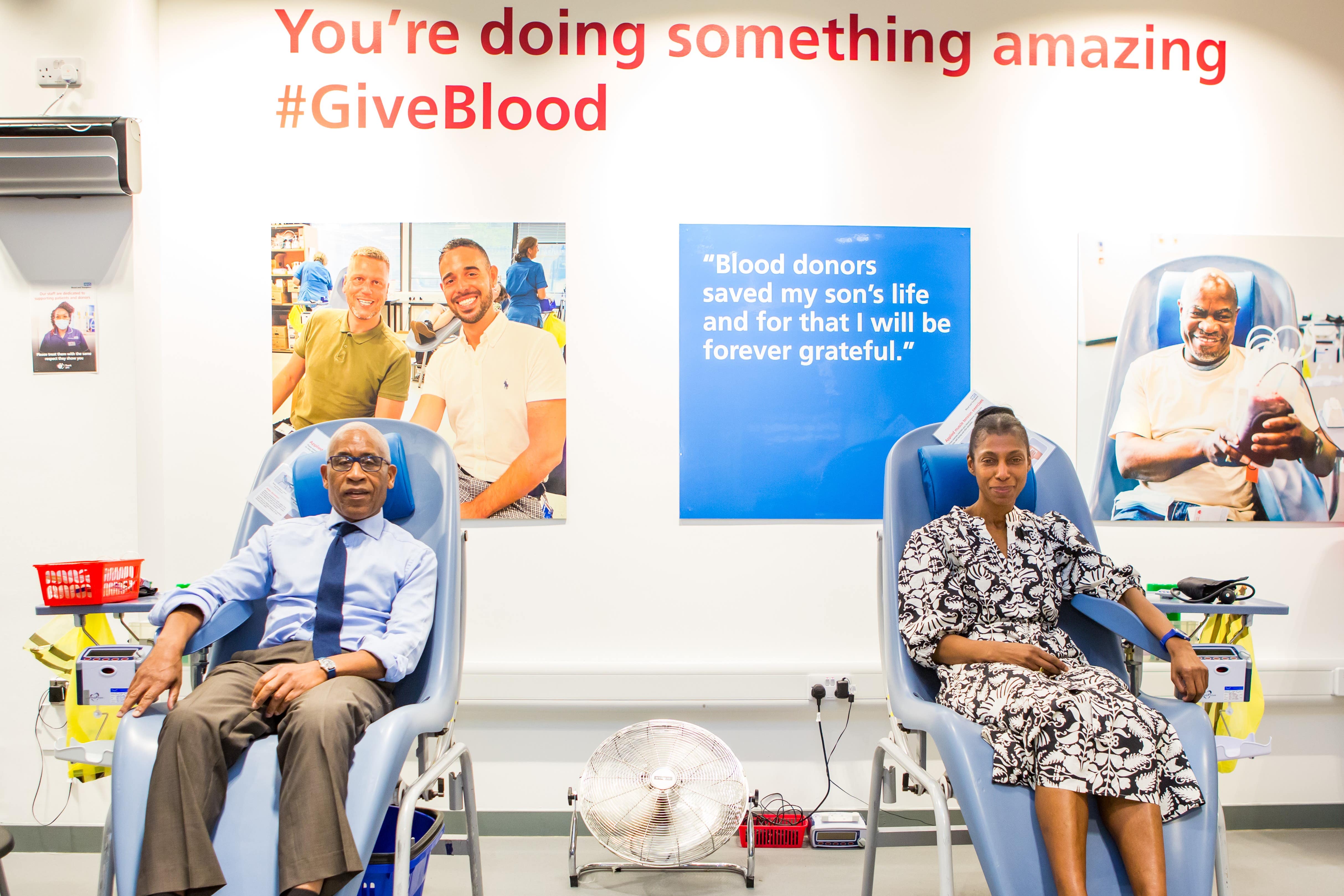 Lord Simon Woolley, left, and Dame Sharon White give blood as a campaign is launched to find more black donors (Rich Barr/PA)