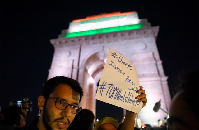 <p>File photo: Indian social activists uses their mobile light as they take part in a solidarity rally protesting over a rape case in Unnao in front of India Gate monument in 2019 </p>