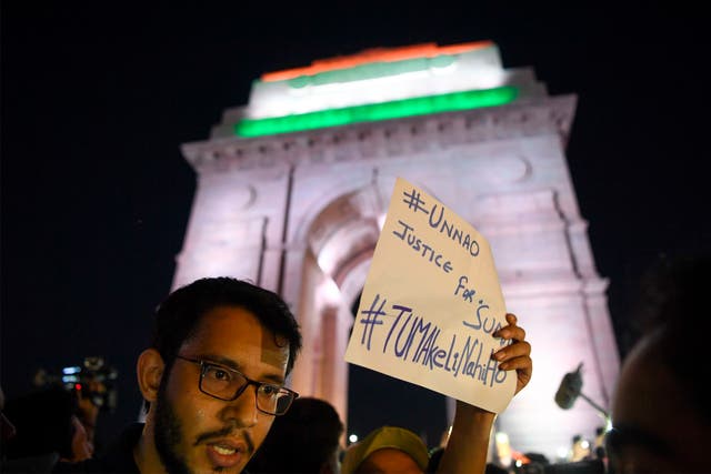 <p>File photo: Indian social activists uses their mobile light as they take part in a solidarity rally protesting over a rape case in Unnao in front of India Gate monument in 2019 </p>
