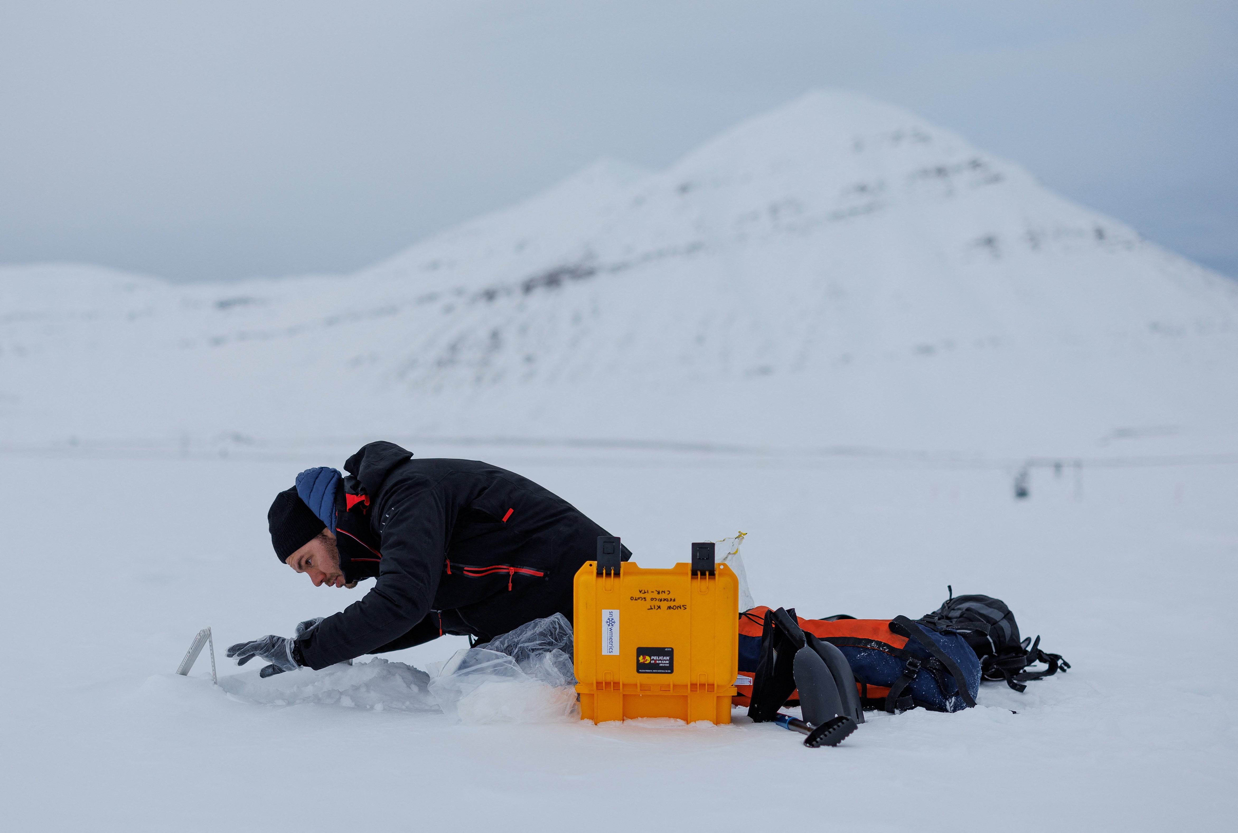Paul Scherrer Institute Switzerland chemist Francois Burgay, 34, prepares to take a snow sample to detect molecules connected to algal bloom in Ny-Alesund, Svalbard, Norway