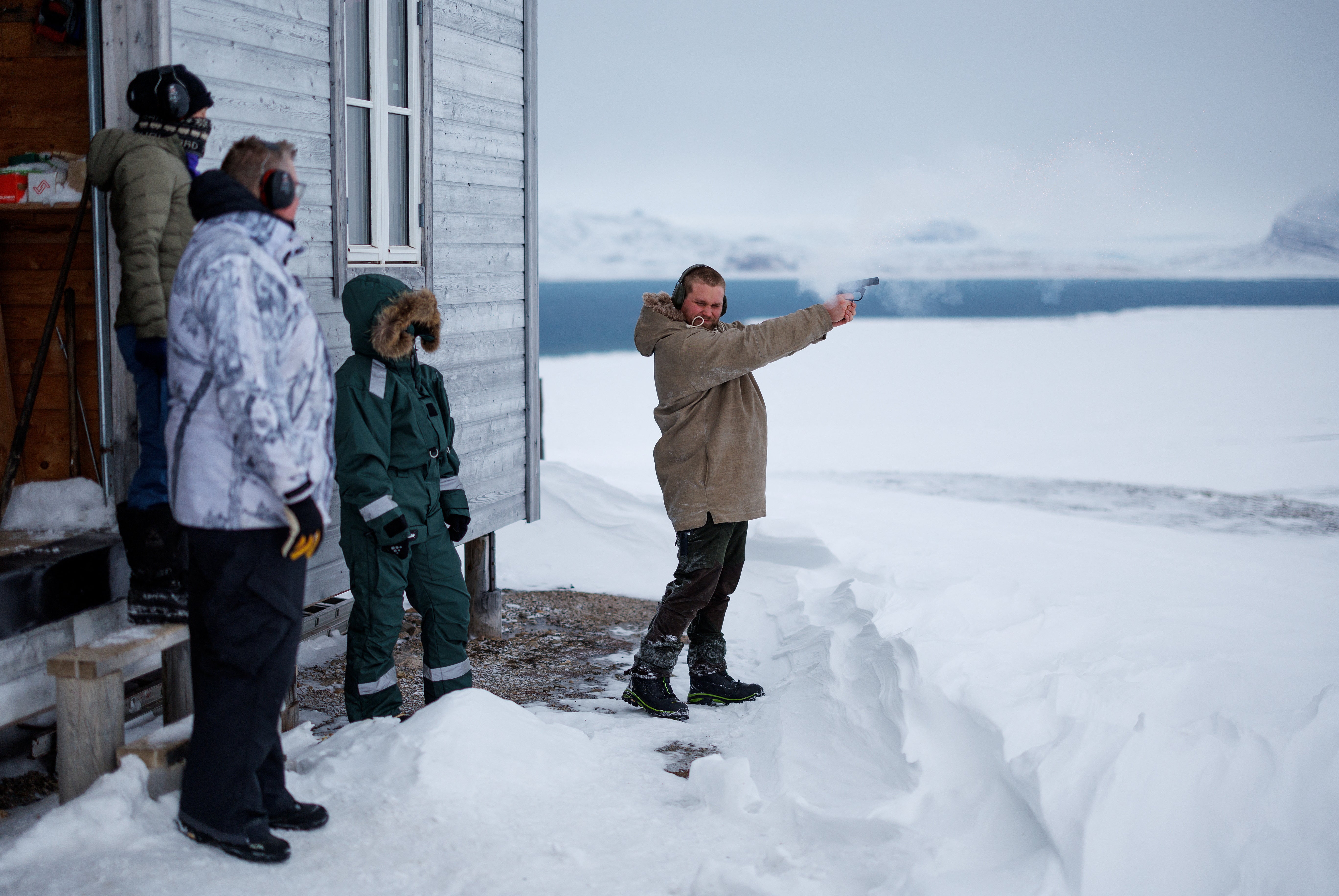 Safety instructor Christer Amundsen demonstrates how to fire a flare gun during training