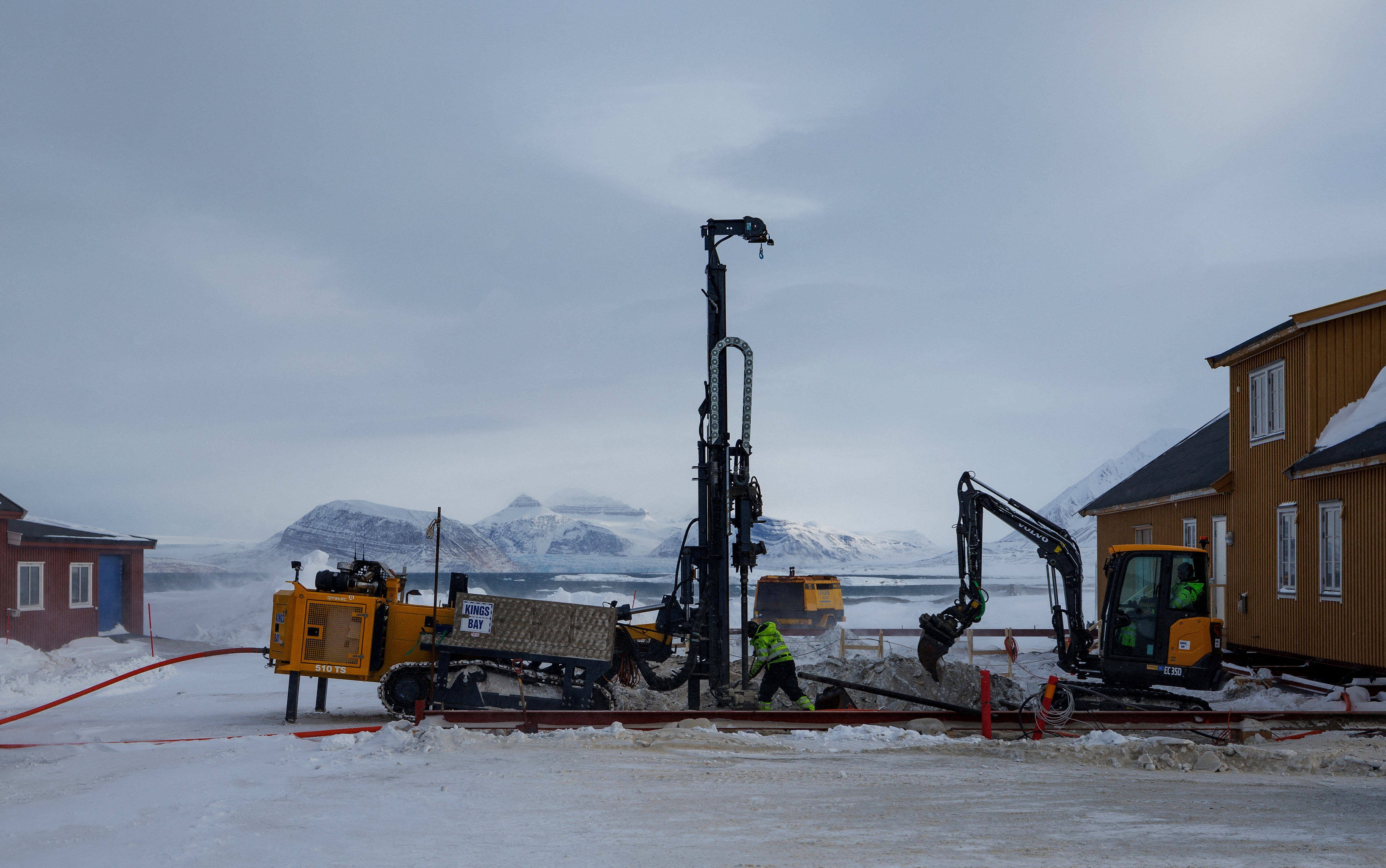 Workers repair the town store after it was damaged by thawing permafrost