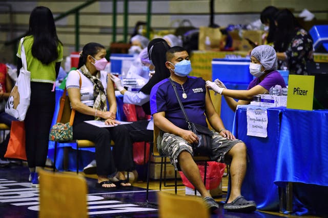 <p>Health workers administer Covid booster jabs inside a stadium in Bangkok</p>