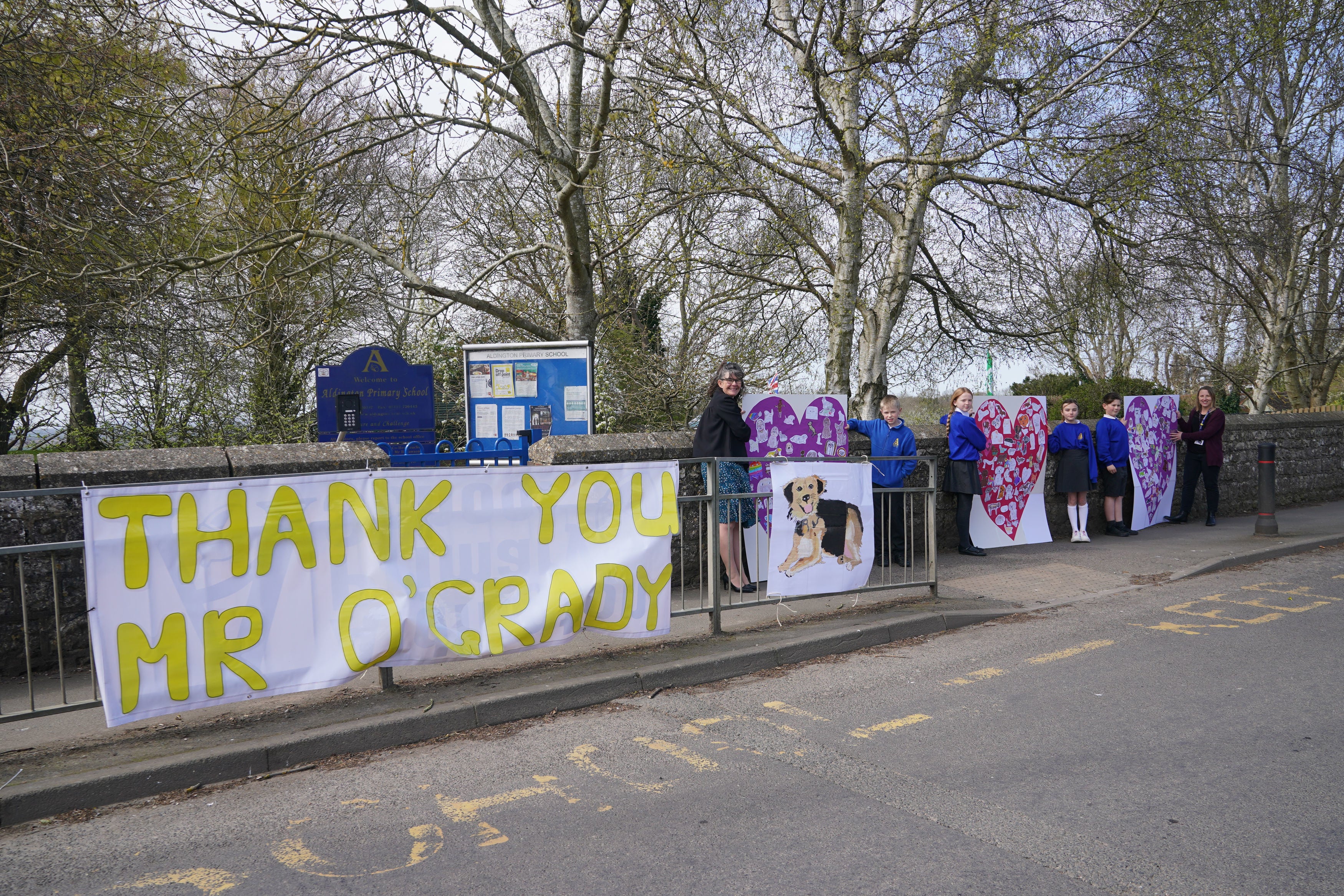 Pupils and teachers from Aldington Primary School pay their respects to Paul O’Grady