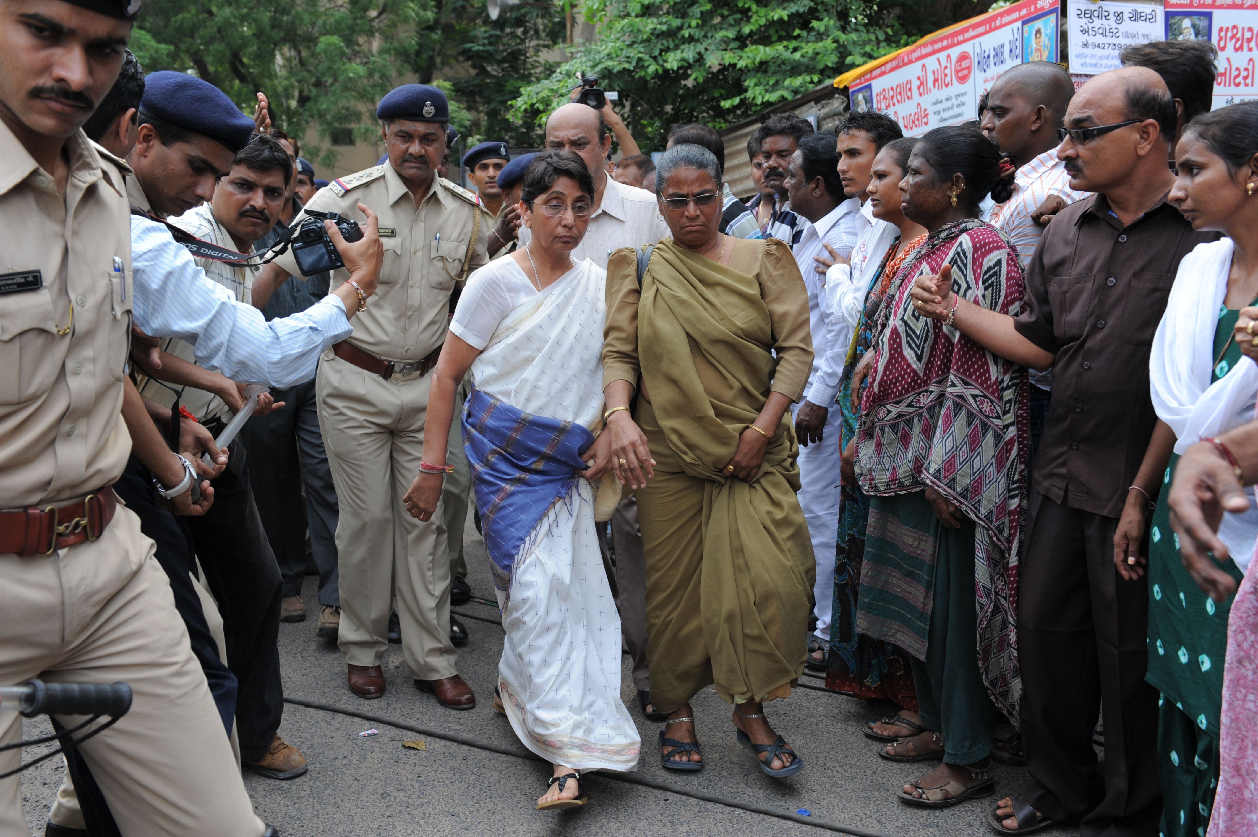 File photo: Former Bhartiya Janta Party MLA and ex-minister in the Narendra Modi state government, Maya Kodnani, is escorted by police on her arrival at a special court in Ahmedabad on 31 August 2012
