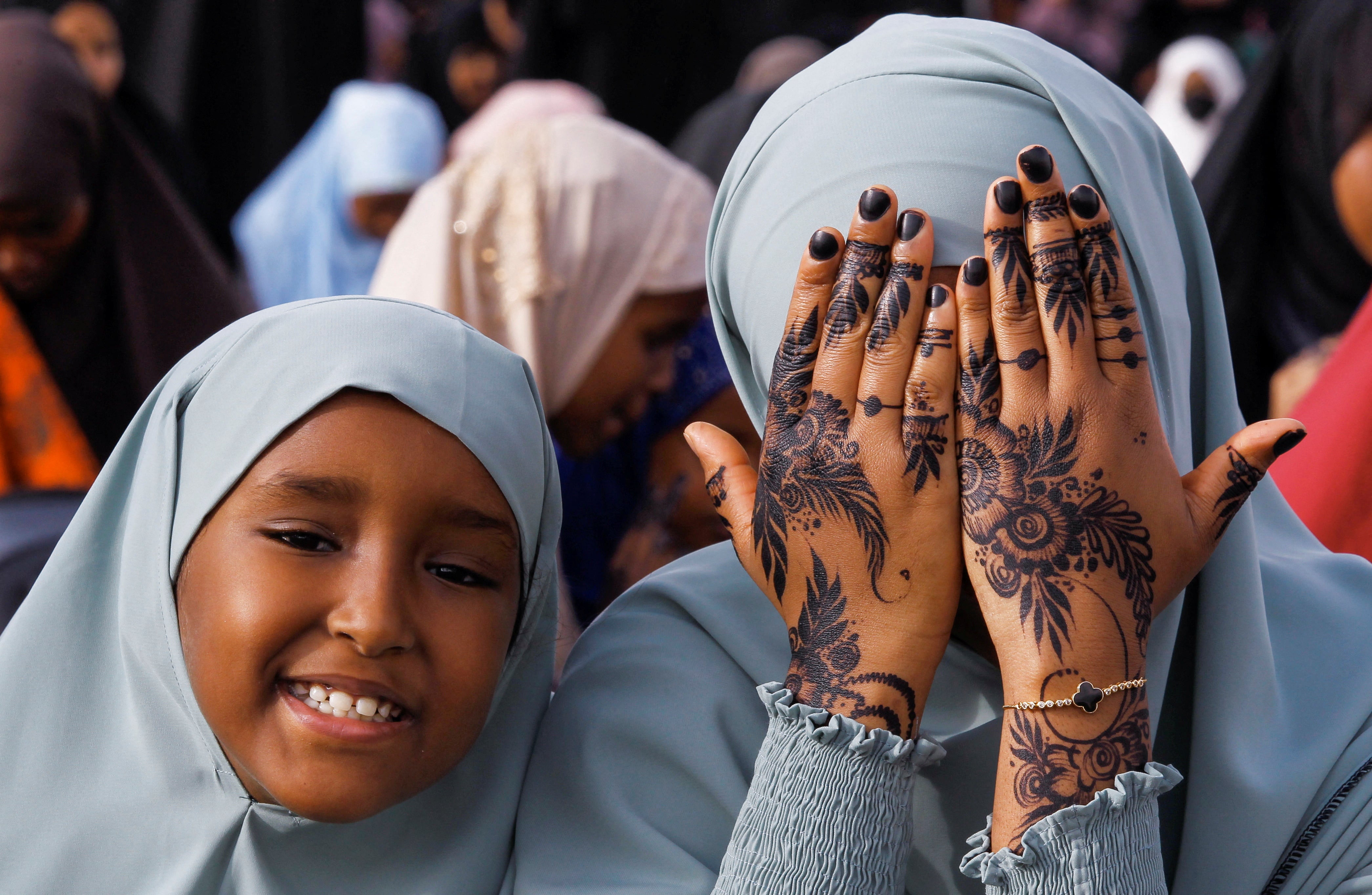 A Muslim faithful displays her henna decoration before attending Eid al-Fitr prayers at the Masjid Salaam grounds in Nairobi, Kenya
