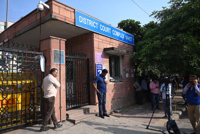 <p>Media representatives stand outside the Saket court complex in New Delhi on 6 November 2019 </p>