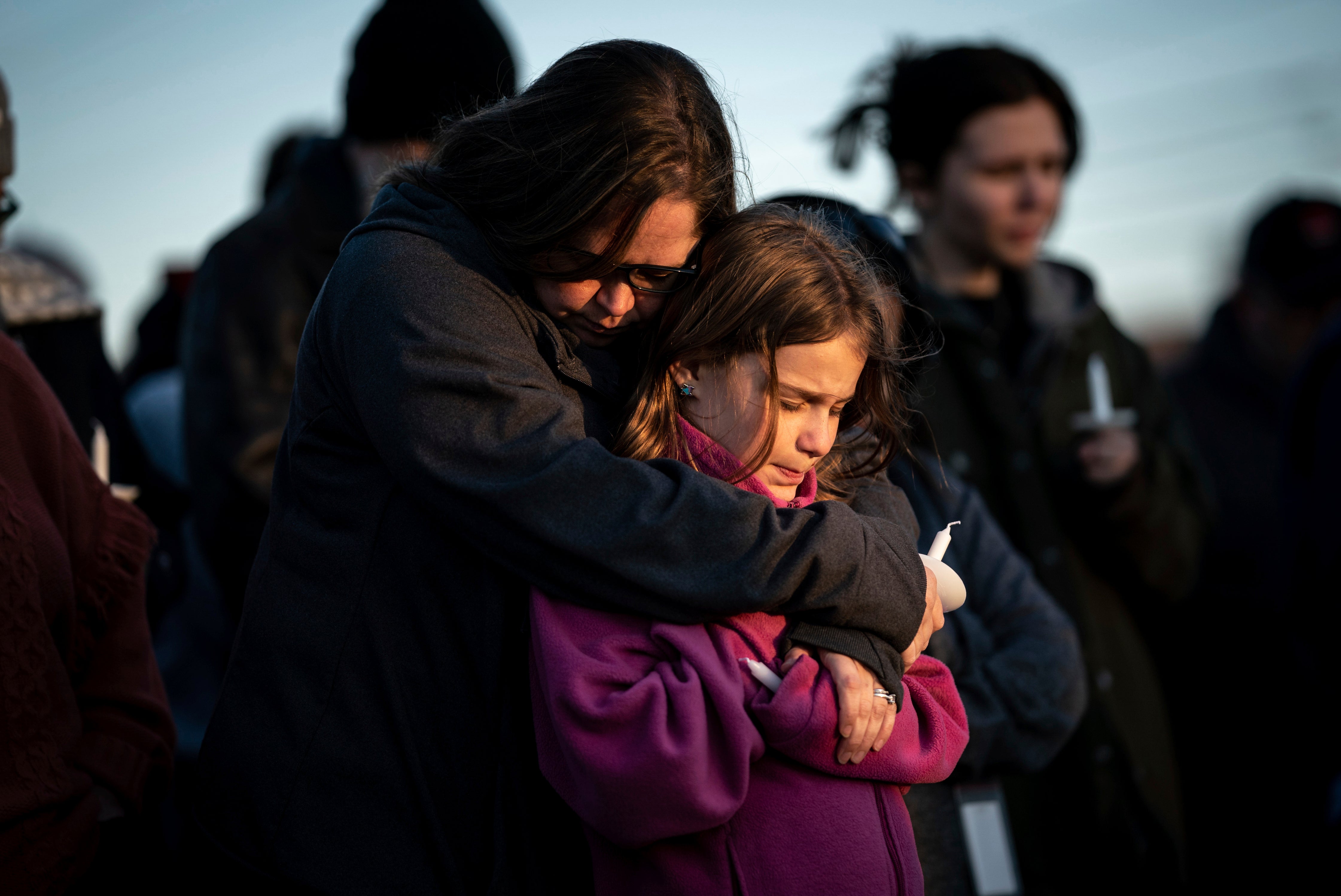 Mourners hug at a vigil following the March school shooting in Nashville which left six dead, not including the shooter killed by police