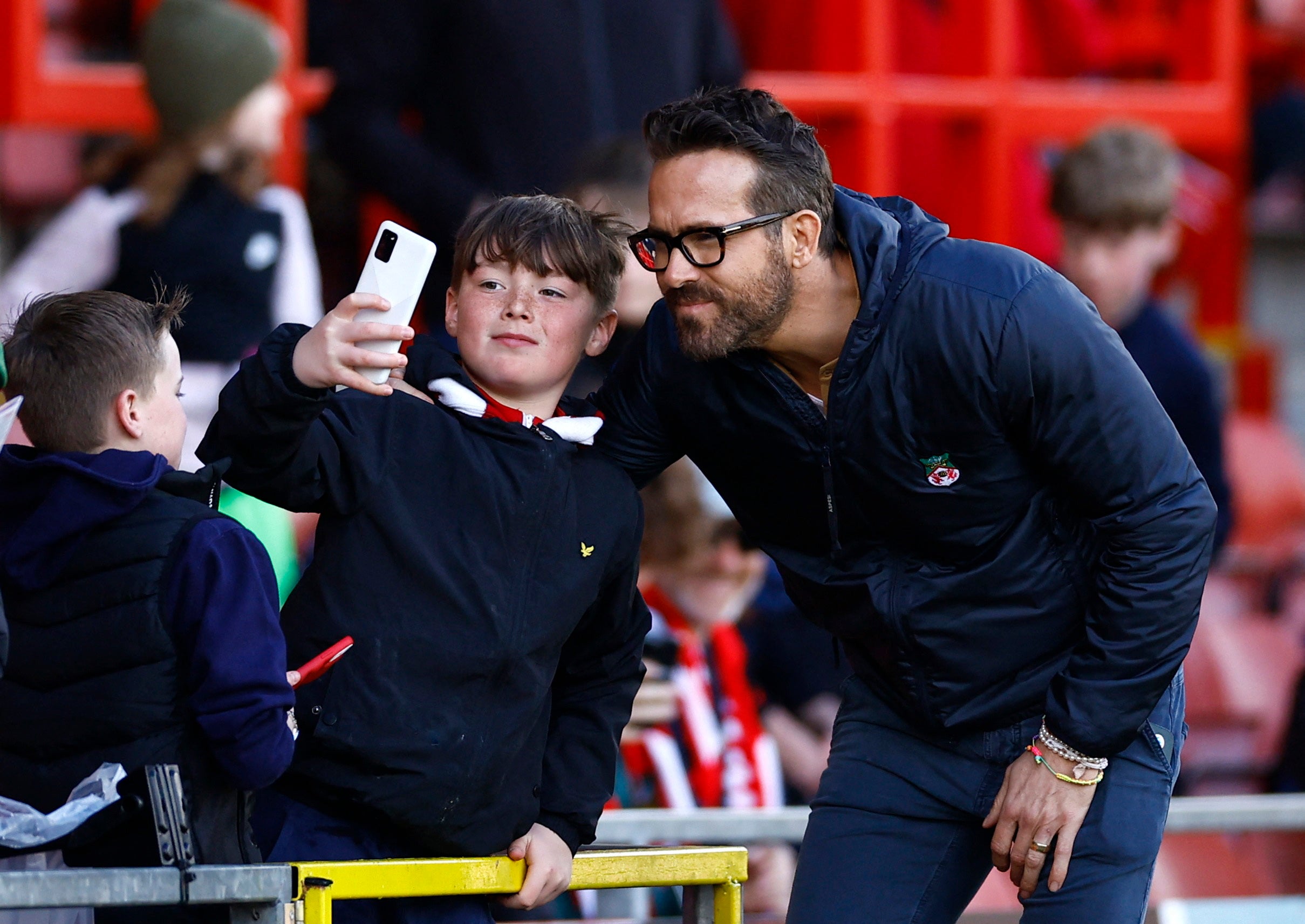 Ryan Reynolds poses for a selfie with a young Wrexham fan